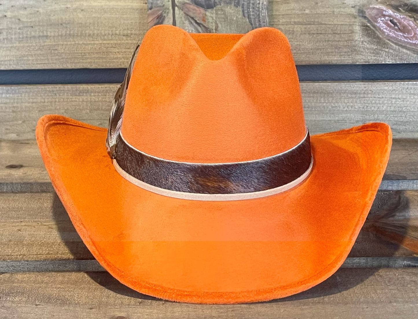 Orange suede cowboy hat with a brindle cowhide band and suede string.
