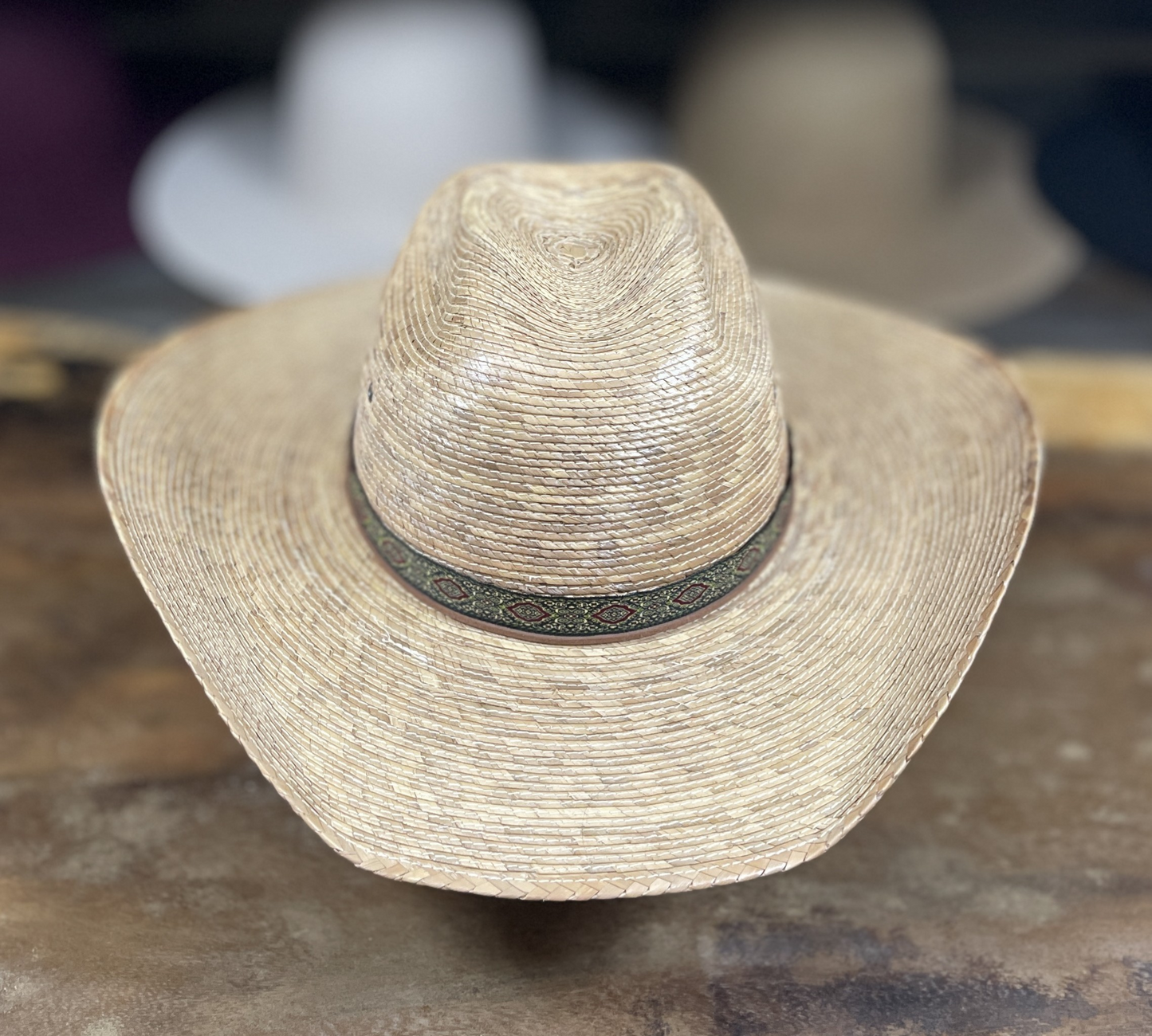 Straw hat with a band on a textured surface