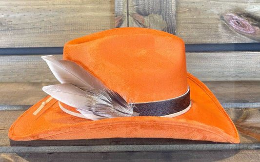Orange suede cowboy hat with a brindle cowhide band, suede string. and Mallard duck feathers.