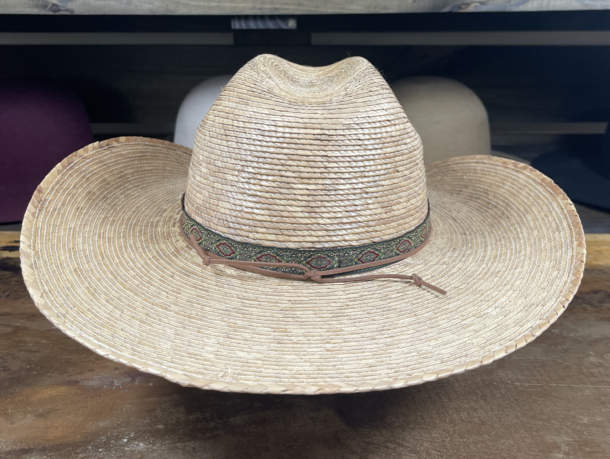 Straw hat with a wide brim on a wooden surface